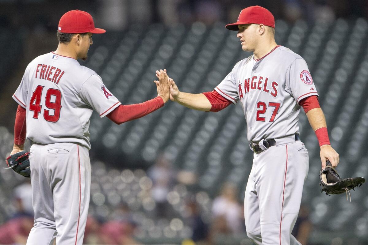 Closing pitcher Ernesto Frieri celebrates with Mike Trout.