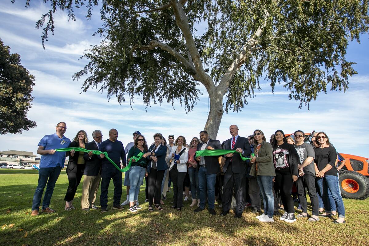 Local leaders cut the ribbon during a ceremony for Park View Park in Huntington Beach on Friday.