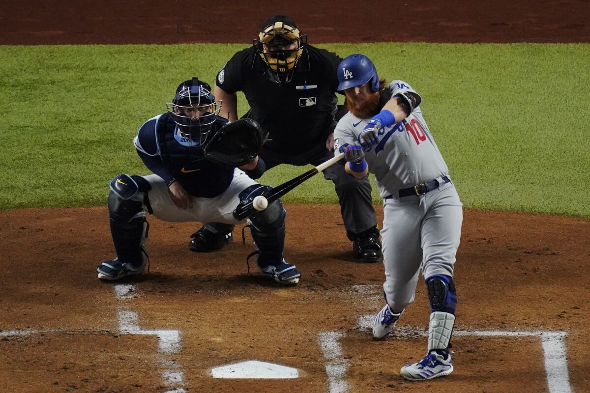 Dodgers third baseman Justin Turner hits a home run during the first inning of Game 3.