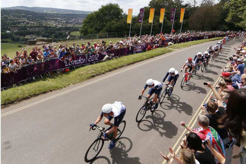 Fans watch riders in the men's road cycling race at the 2012 Olympic Games.