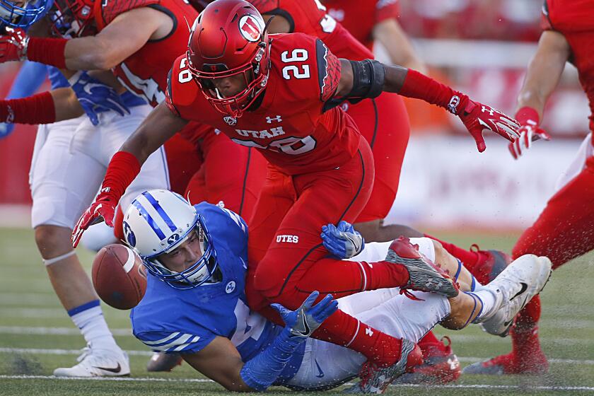 SALT LAKE CITY, UT - SEPTEMBER 10: Terrell Burgess #26 of the Utah Utes fumbles the ball after he was hit by Alema Pilimai #45 of the Brigham Young Cougars during the first half of an college football game, at Rice Eccles Stadium on September 10, 2016 in Salt Lake City, Utah. (Photo by George Frey/Getty Images)
