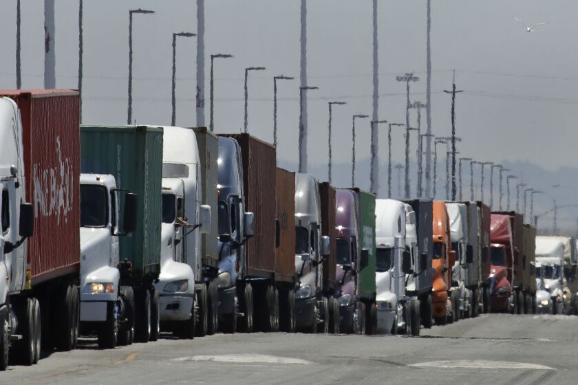 FILE - In this July 22, 2019 photo, trucks hauling shipping containers wait to unload at the Port of Oakland in Oakland, Calif. The Commerce Department issues its second estimate of how the U.S. economy performed in the first quarter of 2020 on Thursday, May 28, 2020.(AP Photo/Ben Margot, File)