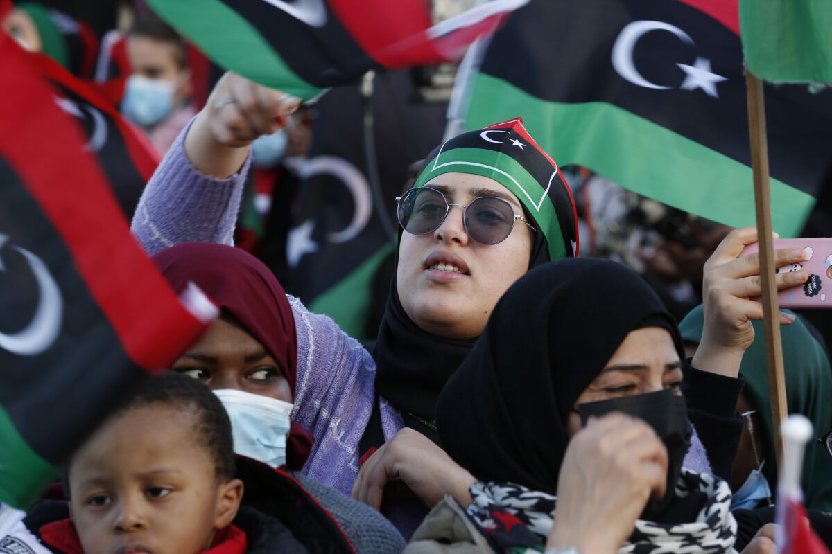 FILE - Libyans celebrate February Revolution Day in Martyrs' Square in Tripoli, Libya, Feb. 18, 2022. Two separate governments are once again vying for power in Libya. It's the latest setback, reversing tentative steps toward unity in the past year, including promised elections that never materialized. Clashes in the country's capital of Tripoli last month underscored the fragility of Libya's relative peace that has prevailed for more than a year. (AP Photo/Yousef Murad, File)