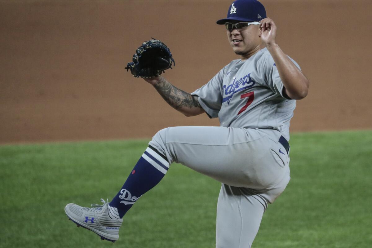 Dodgers starting pitcher Julio Urias follows through as he strikes out San Diego Padres second baseman Jake Cronenworth.