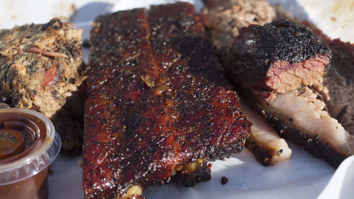 A plate of pulled pork, pork ribs and brisket from Moo's Craft Barbecue.