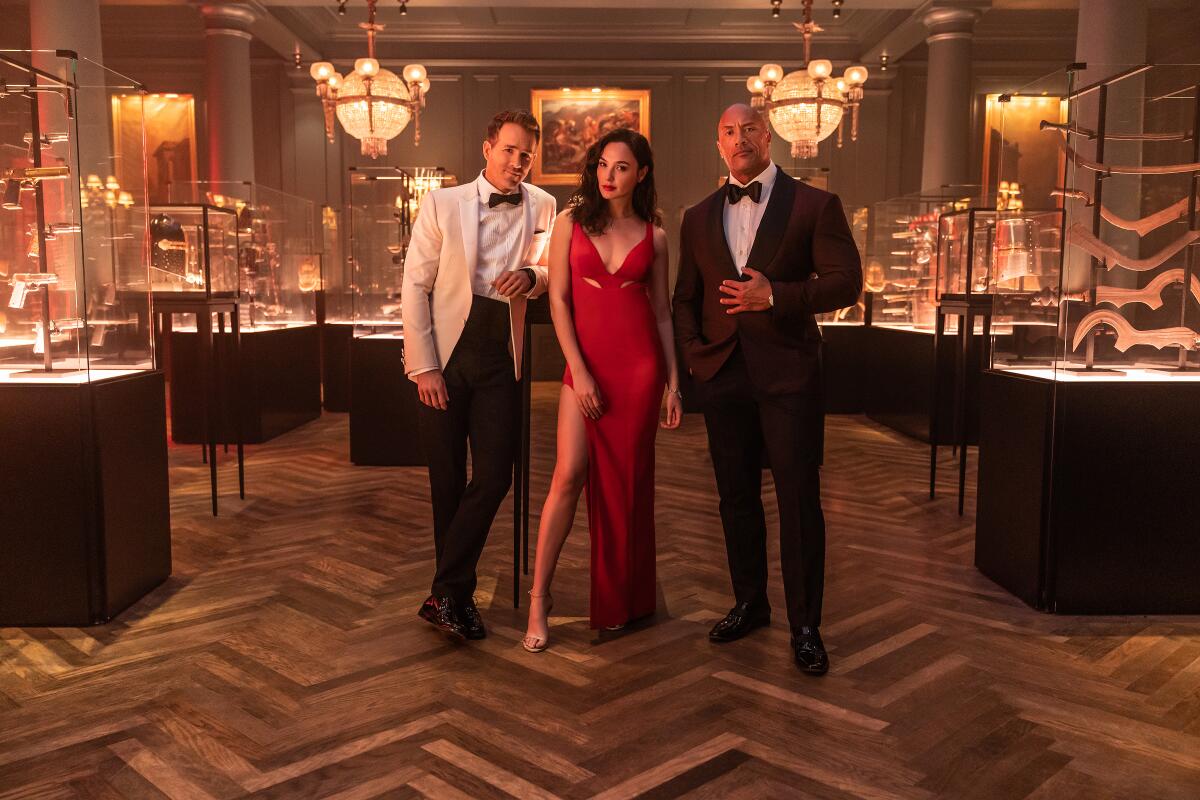Ryan Reynolds, Gal Gadot and Dwayne Johnson in the movie "Red Notice."