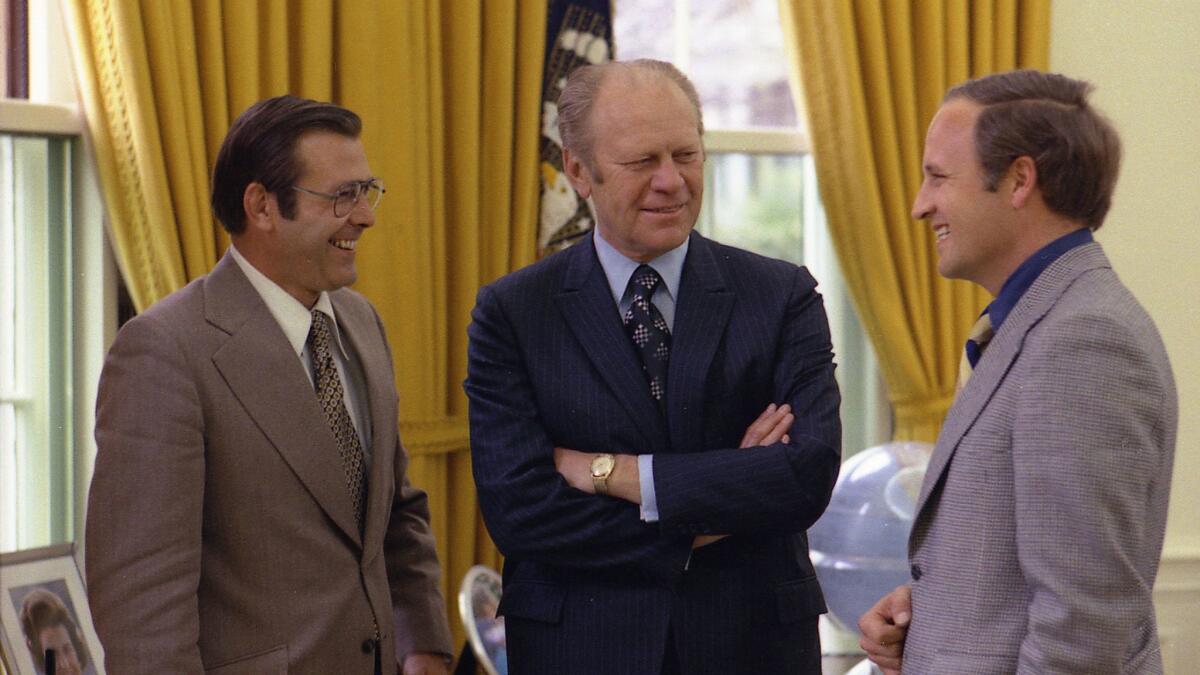 Donald Rumsfeld, left, was chief of staff for Gerald Ford, center, in April 1975. He was succeeded in the position by Dick Cheney, right. (David Hume Kennerly / Associated Press)