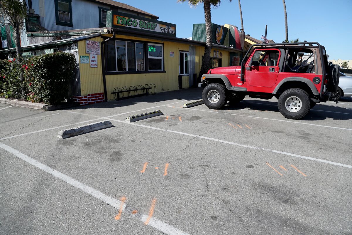 Orange spray paint marks the path of a vehicle that collided into the front of Taco Surf in Surfside Sunday morning.