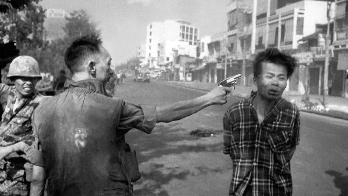 South Vietnamese Gen. Nguyen Ngoc Loan fires his pistol into the head of suspected Viet Cong officer Nguyen Van Lem on a Saigon street, early in the Tet Offensive.
