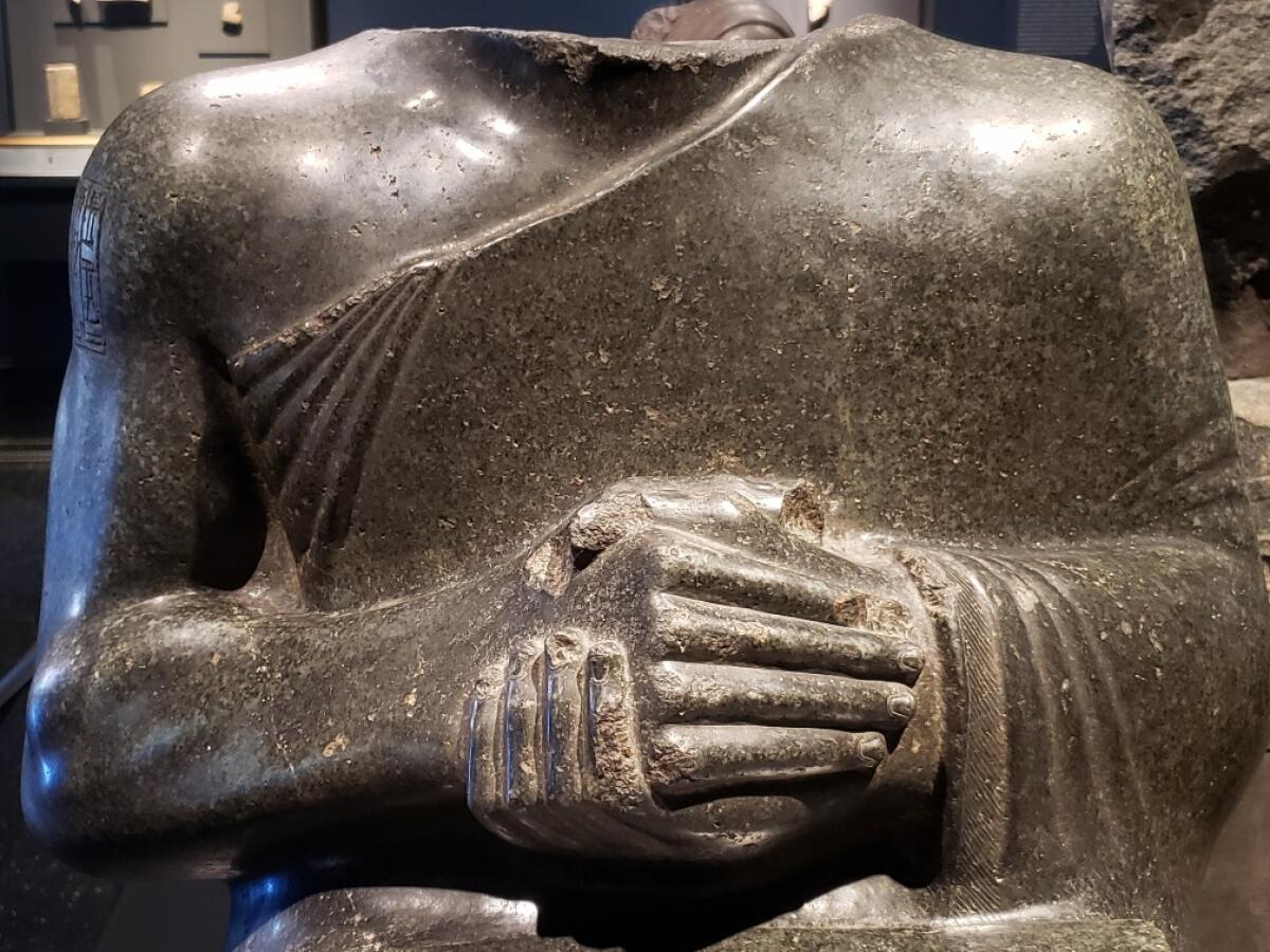 A detail of a statue of Prince Gudea, showing powerful hands.