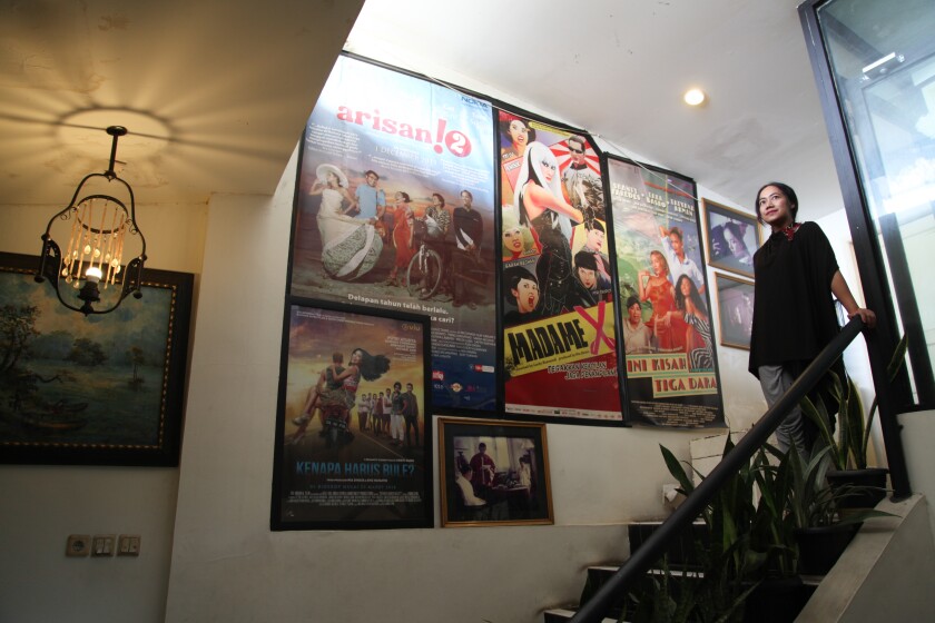 Posters from Indonesian films depicting gay and transgender protagonists adorn the walls of director Nia Dinata's office in Jakarta.