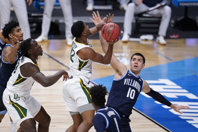 Baylor guard Jared Butler (12) shoots on Villanova forward Cole Swider (10) in the first half of a Sweet 16 game in the NCAA men's college basketball tournament at Hinkle Fieldhouse in Indianapolis, Saturday, March 27, 2021. (AP Photo/Mike Conroy)