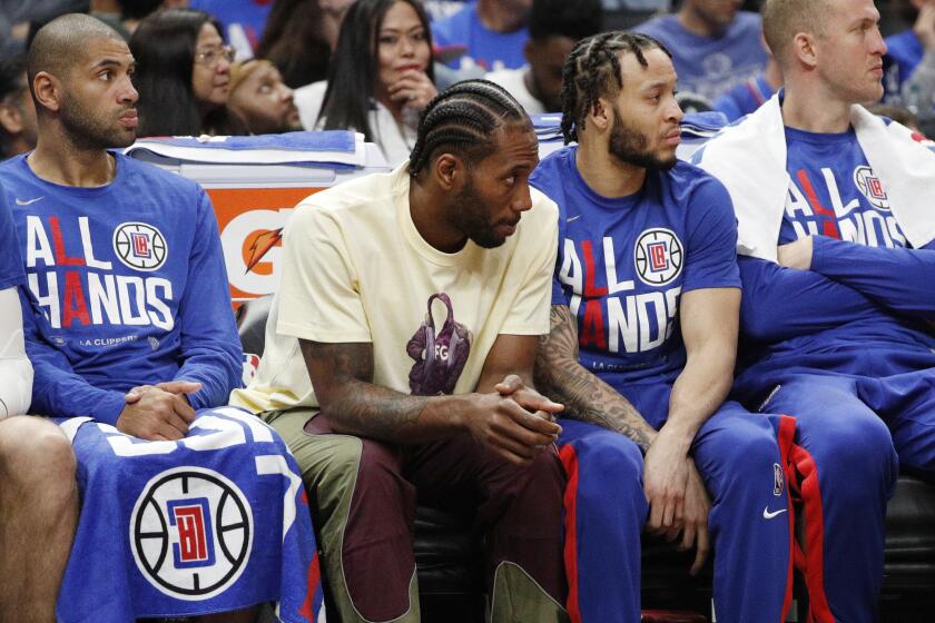 LA Clippers bench with Kawhi Leonard sitting out is despondent in their loss to the Phoenix Suns