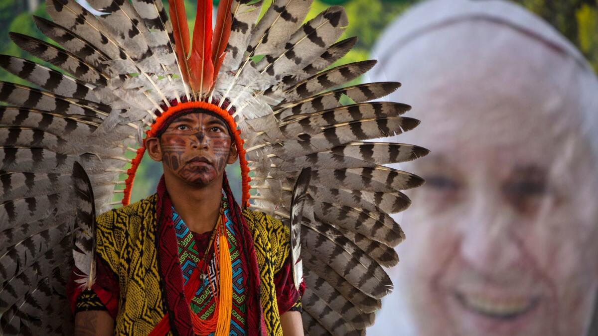 A day before Pope Francis arrives in Puerto Maldonado, Peru, Huni Kuin member Antonio Borges Serum prepares to perform a dance during a meeting of Amazonian indigenous people.
