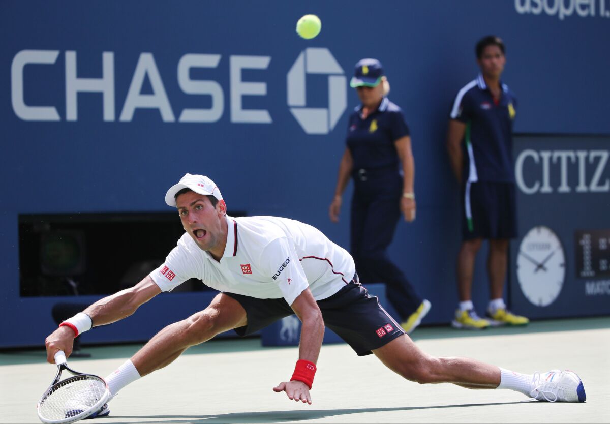 Novak Djokovic returns a shot to Kei Nishikori during Saturday's semifinals of the U.S. Open.