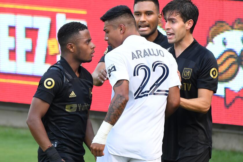 LOS ANGELES, CALIFORNIA AUGUST 22, 2020-Galaxy's Julian Araujo (22) gets in an argument with LAFS's Eddie Segura, left, in the 1st half at Banc of California Stadium in Los Angeles Saturday. (Wally Skalij/Los Angeles Times)
