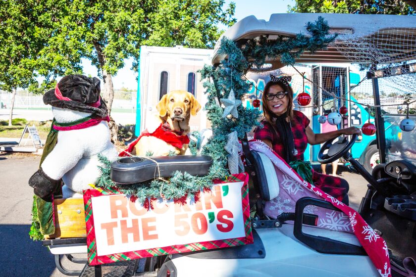Linda Rosas with her dog, Winnie, in their entry with the PB Golf Cart Gang.