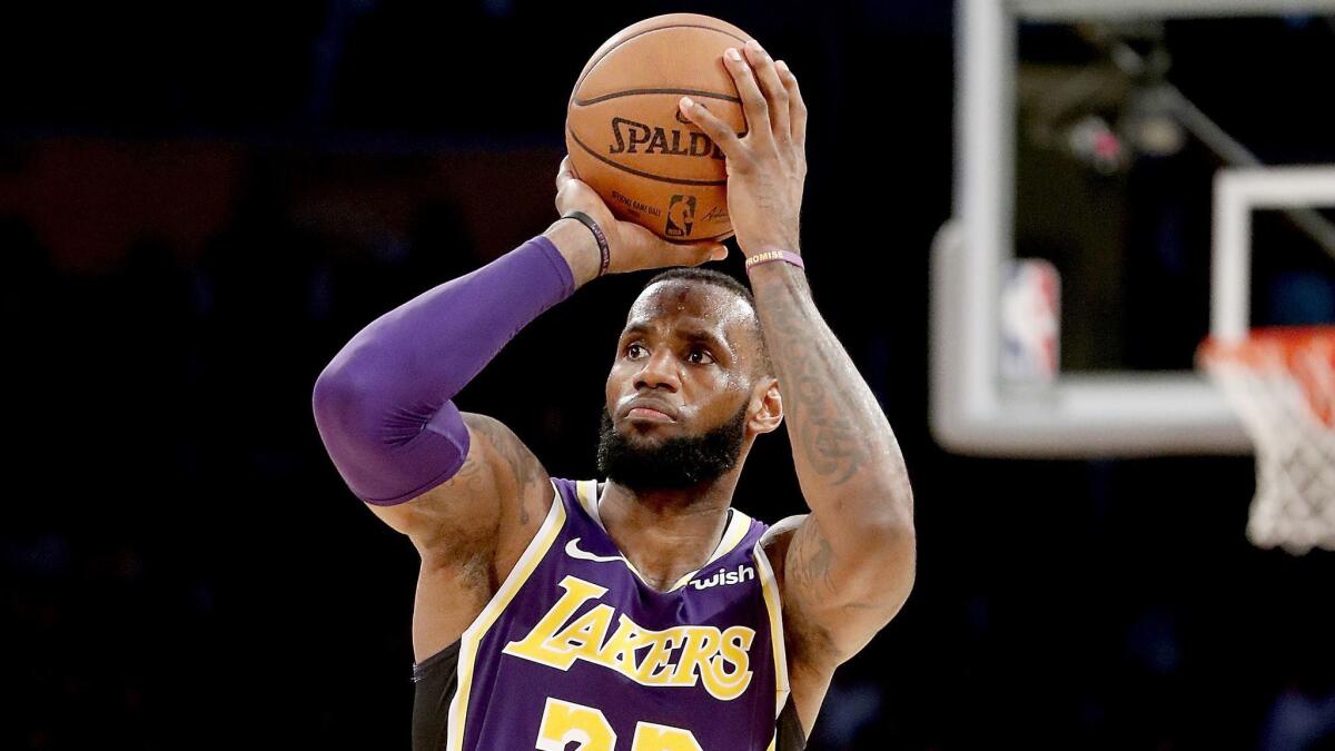 LeBron James of the Lakers shoots and scores a three-pointer against the San Antonio Spurs on Dec. 5, 2018, at Staples Center.