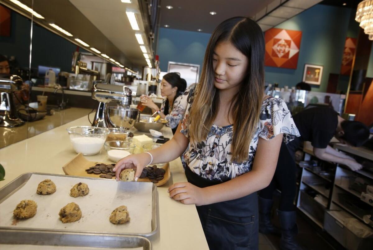 Elia Min makes chocolate chip cookies at her mother's shop, Rubies + Diamonds cafe, in Hollywood.