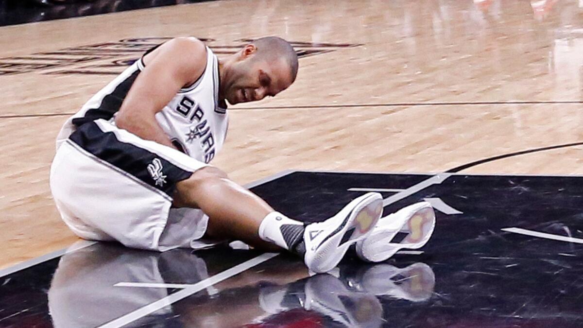 San Antonio guard Tony Parker lies on the court after sustaining a leg injury against Houston on May 3.