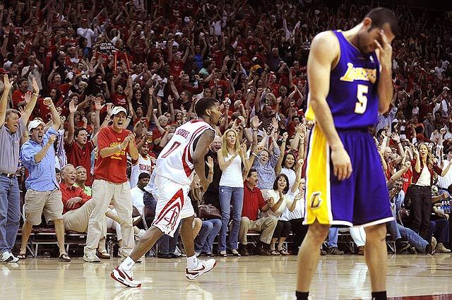 Rockets Aaron Brooks celebrates along with the crowd while making a basket with .07 at the end of the 3rd quarter in front of Lakers Jordan Farmar during Game 4 of their Western Conference semifinal series in Houston.