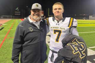 Newbury Park High coach Joe Smigiel, left, and son Brady, the Panthers' quarterback, pose for a photo Friday night.