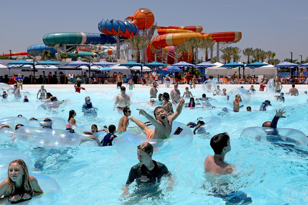 Guests ride the waves at Shaka Bay at Wild Rivers water park in Irvine.
