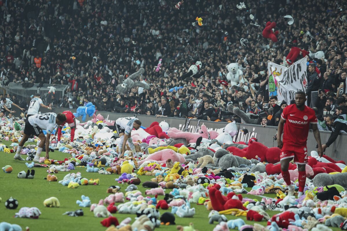 Fans throw toys onto the pitch during the soccer match between Besiktas and Antalyaspor at the Vodafone stadium in Istanbul