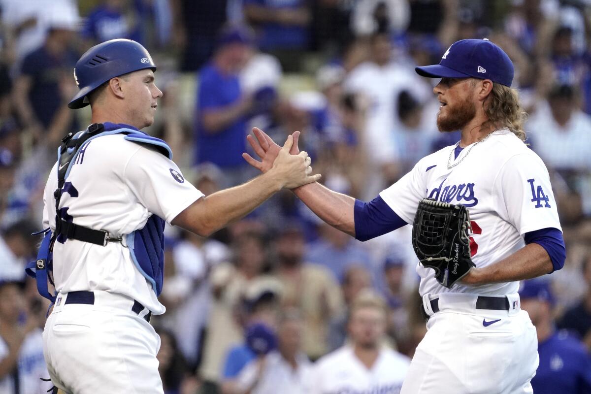 Dodgers catcher Will Smith, left, and relief pitcher Craig Kimbrel celebrate.