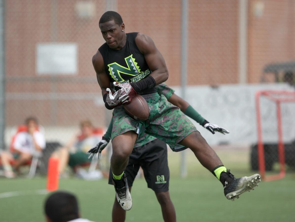 Narbonne linebacker Lawson Hall intercepts a pass against Edison during a summer passing league tournament in Huntington Beach.