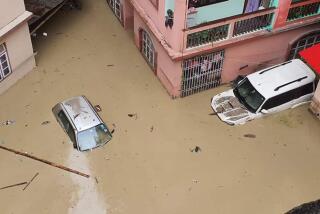 Cars lie submerged in water after flash floods triggered by a sudden heavy rainfall swamped the Rangpo town in Sikkim, India, Thursday, Oct.5. 2023. The flooding took place along the Teesta River in the Lachen Valley of the north-eastern state, and was worsened when parts of a dam were washed away. (AP Photo/Prakash Adhikari)
