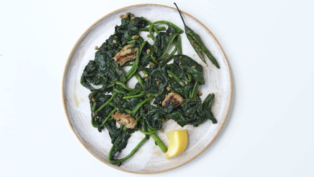 Mam tom, the Vietnamese shrimp paste, makes a umami-rich sauce for this stir-fry of water spinach and pork. Prop styling by Nidia Cueva.