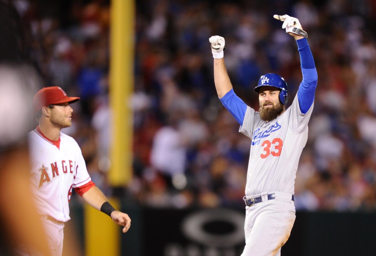 Dodgers outfielder Scott Van Slyke celebrates his two-run double in the seventh inning against the Angels.