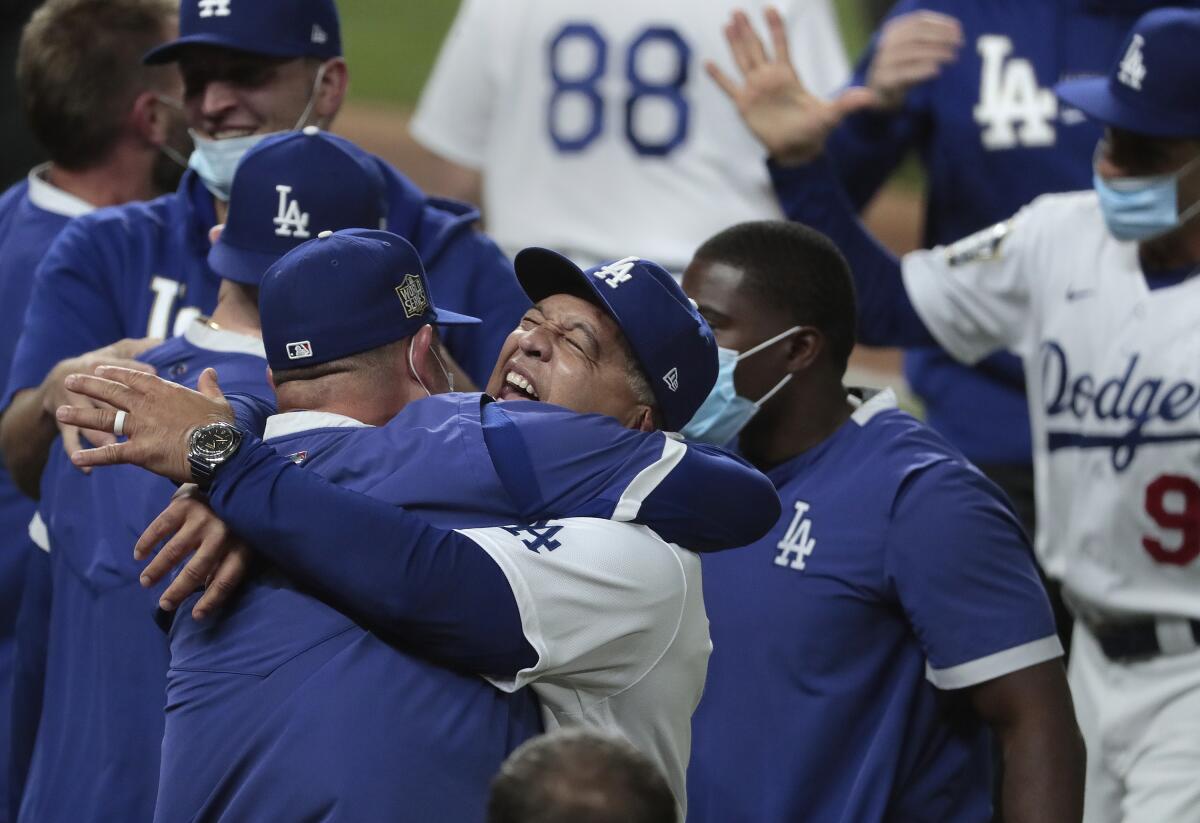 Dodgers manager Dave Roberts celebrates with the team after clinching the World Series at Globe Life Field. 