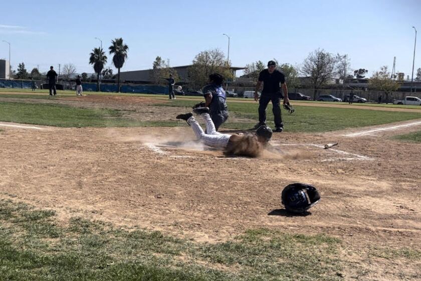 Ruben Lira of Sun Valley Poly slides in safely to score during a 4-3 win over North Hollywood.