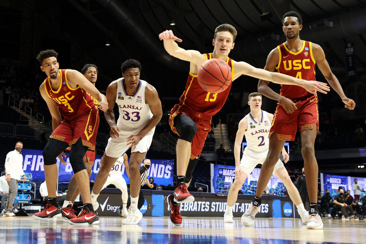 USC's Drew Peterson chases after a loose ball in front of Isaiah (3) and Evan Mobley (4).