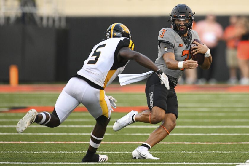 Arkansas-Pine Bluff linebacker Isaac Peppers (5) chases down Oklahoma State quarterback Spencer Sanders during the first half of an NCAA college football game, Saturday, Sept. 17, 2022, in Stillwater, Okla. (AP Photo/Brody Schmidt)
