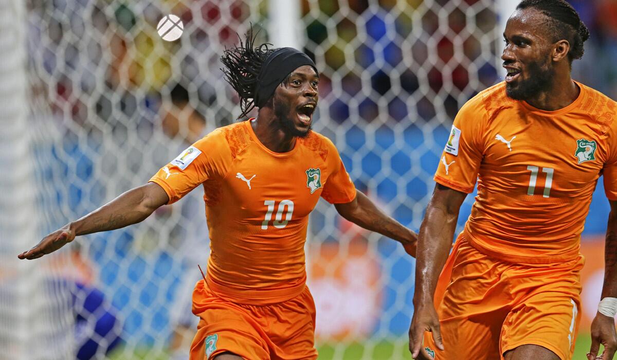 Ivory Coast forward Gervinho (10) celebrates with teammate Didier Drogba (11) after scoring what proved to be the winning goal against Japan on Saturday in a World Cup Group C game at the Arena Pernambuco in Recife, Brazil.