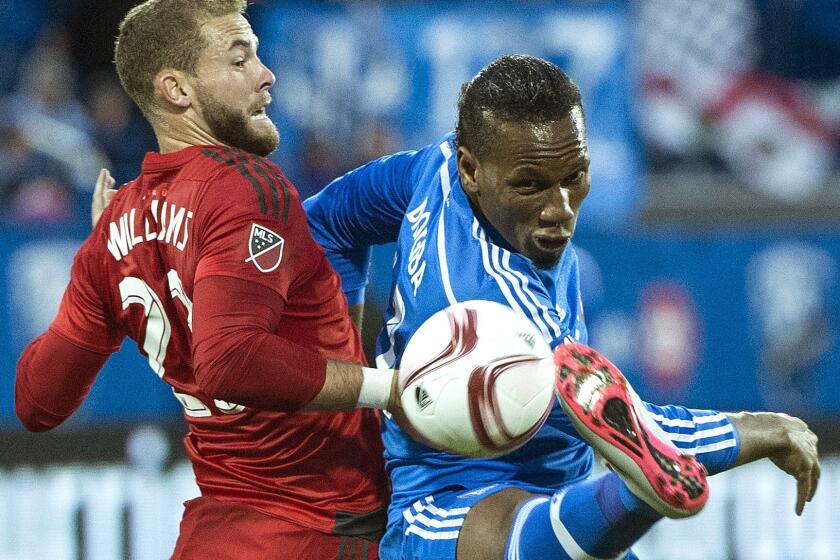 Impact forward Didier Drogba, right, tries to control the ball against Toronto FC's Josh Williams in the first half Thursday night.