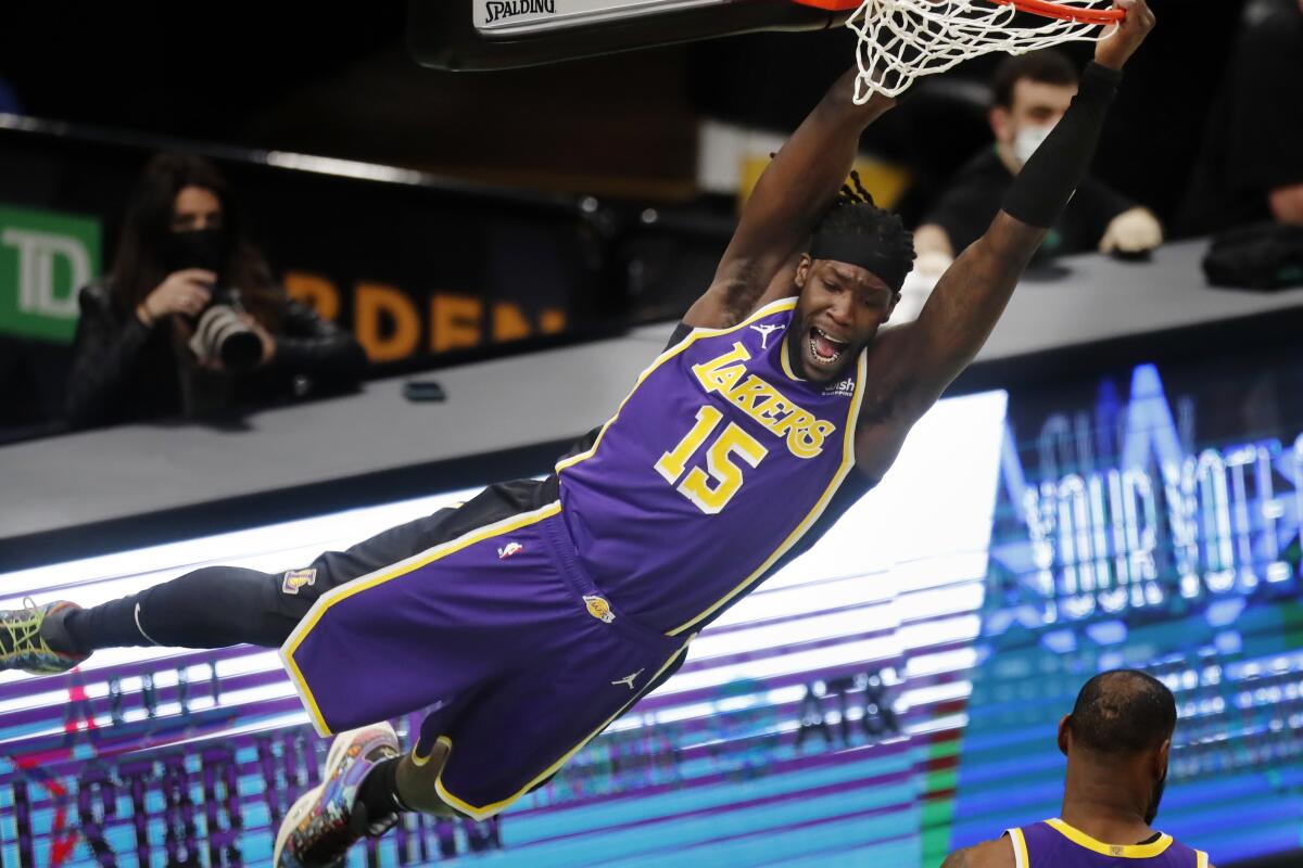 Lakers forward Montrezl Harrell hangs from the rim after a dunk in the second quarter.