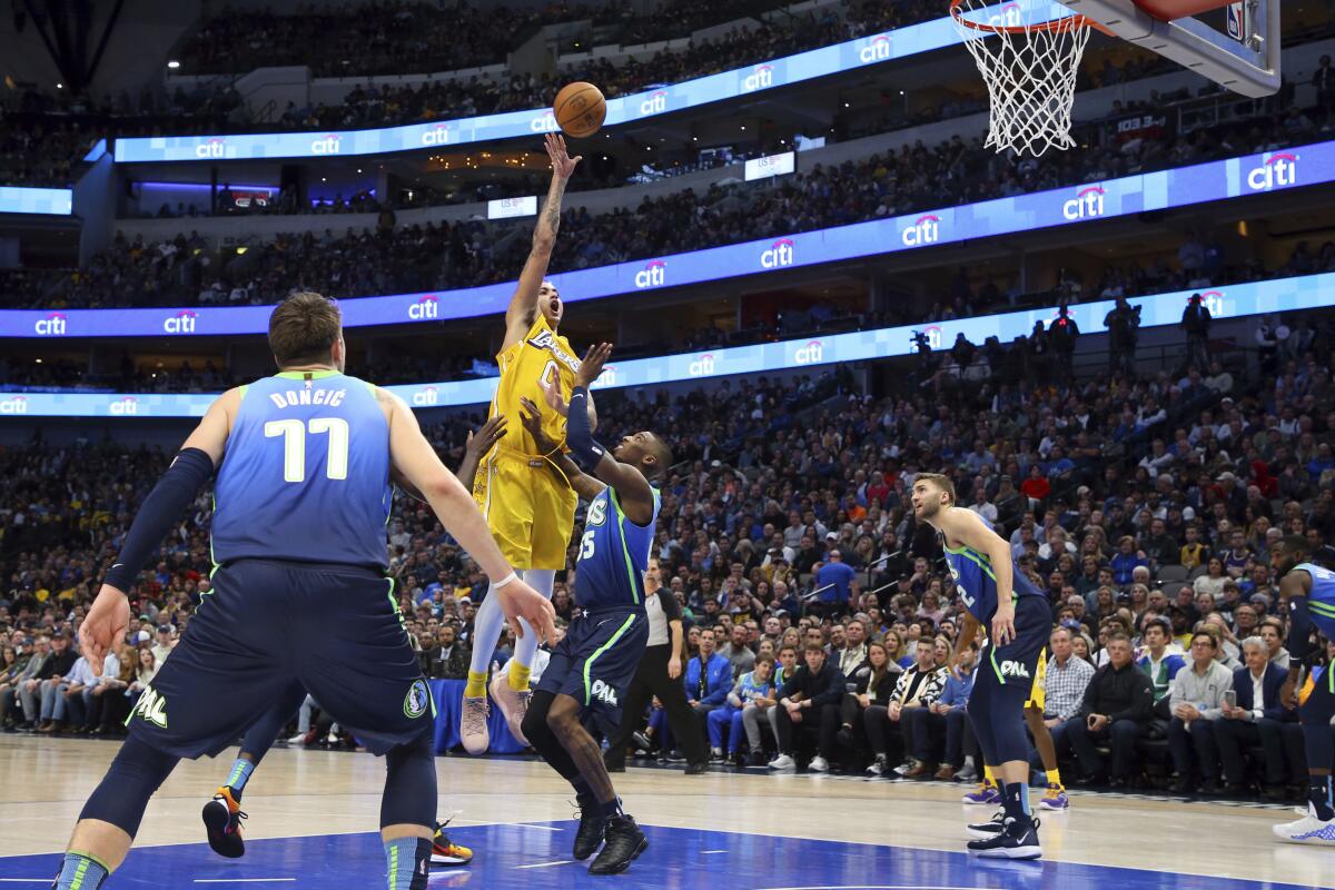 The Lakers' Kyle Kuzma, who scored a season-high 26 points, shoots over the Mavericks' Delon Wright on Jan. 10, 2020.