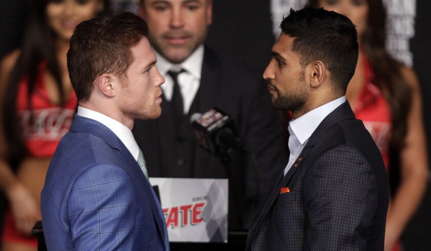 Saul "Canelo" Alvarez, left, and Amir Khan face off during their final press conference at the MGM Grand in Las Vegas on Wednesday.