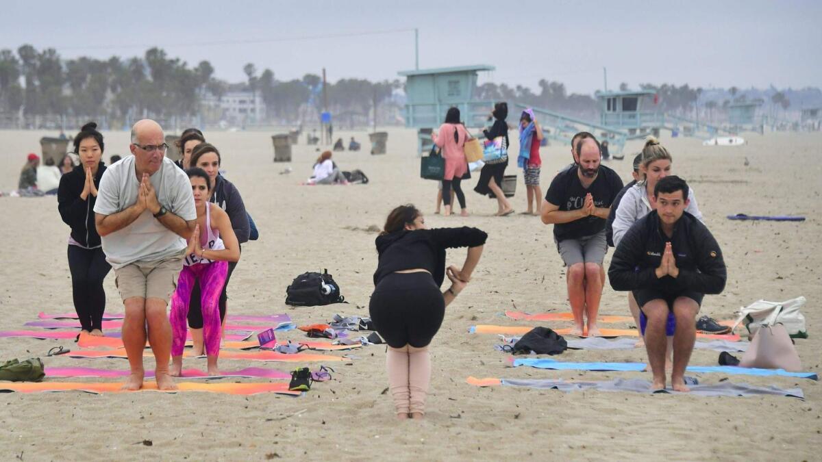 Yoga instructor Vee Gomez leads a beach yoga class on an overcast evening in Santa Monica on June 21 to celebrate International Yoga Day, which is also the summer solstice.