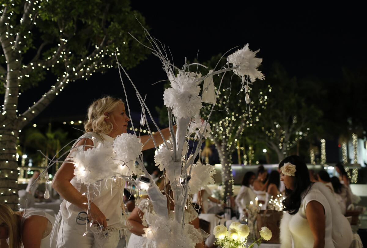 A woman works on her centerpiece at Diner en Blanc.