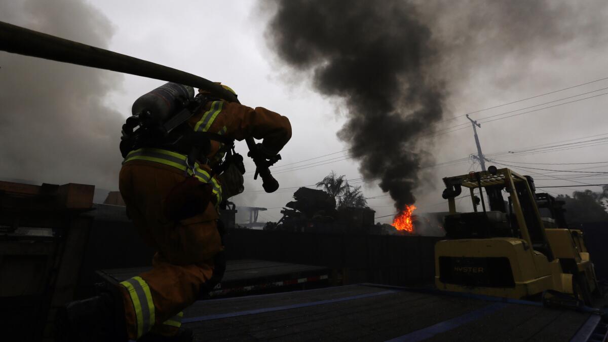 A firefighter attacks the blaze in the 3500 block of Fruitland Avenue in Maywood.