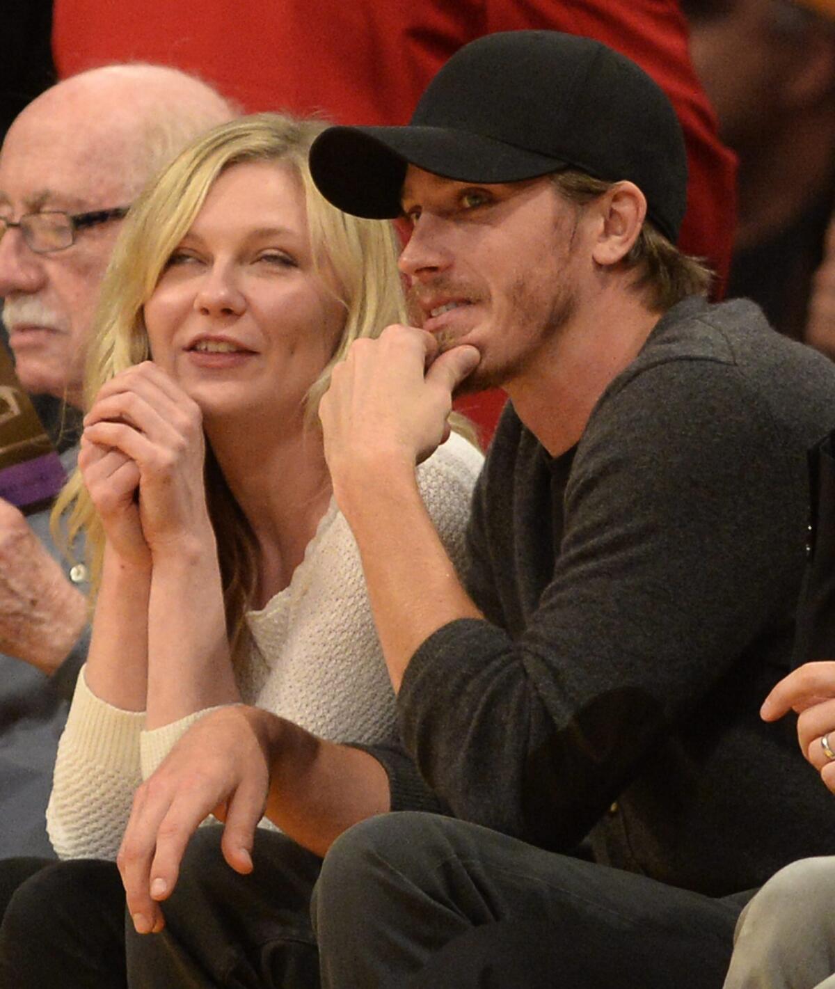 Kirsten Dunst is seen at a Lakers game with actor Garrett Hedlund at Staples Center.