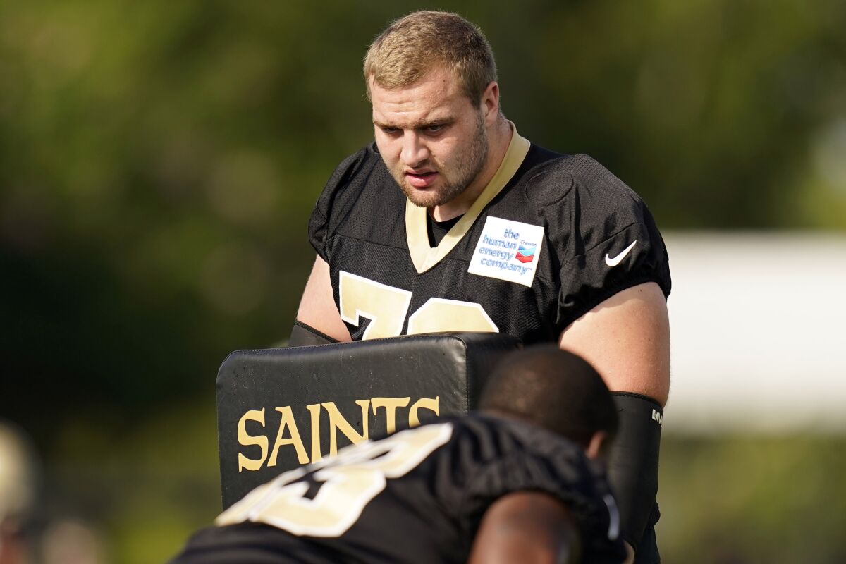 FILE - New Orleans Saints offensive tackle Trevor Penning (70) works on a blocking drill during NFL football training camp in Metairie, La., Saturday, July 30, 2022. The Saints first-round draft choice has been at the center of a few training camp skirmishes this week as he fights for playing time at left tackle. (AP Photo/Gerald Herbert, File)