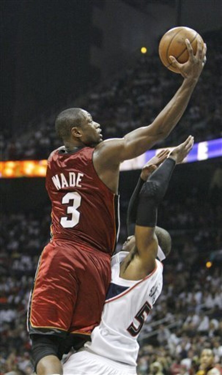 Miami heat's Dwyane Wade (3) fouls Atlanta hawks' Josh Smith whiile driving to the basket in the second half of Game 7 of the Eastern Conference NBA basketball playoff series Sunday, May 3, 2009. Atlanta won 91-78. (AP Photo/John Bazemore)