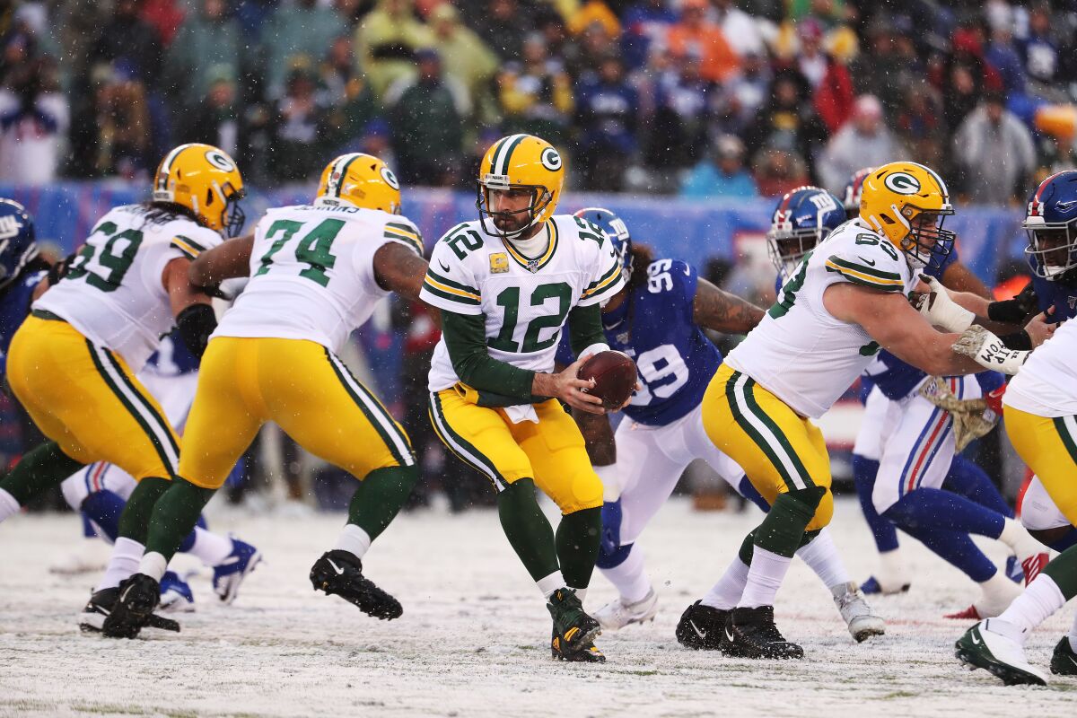 Green Bay Packers quarterback Aaron Rodgers looks to hand off the ball.