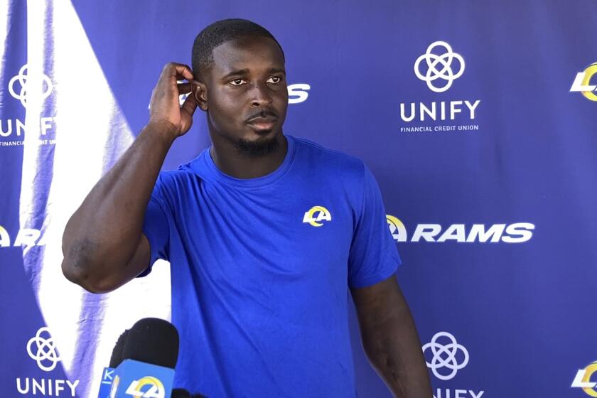 In this image taken video, Los Angeles Rams running back Sony Michel speaks with reporters at the NFL football team's training complex in Thousand Oaks, Calif., Thursday, Aug. 26, 2021. Michel watched his first practice with his new team after the Rams acquired the former Super Bowl star from the New England Patriots earlier in the week. (AP Photo/Greg Beacham)